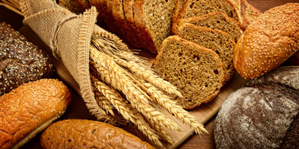 Some loafs of bread and some wheat